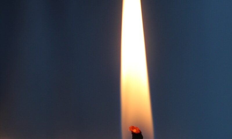 selective focus photography of lighterd candle